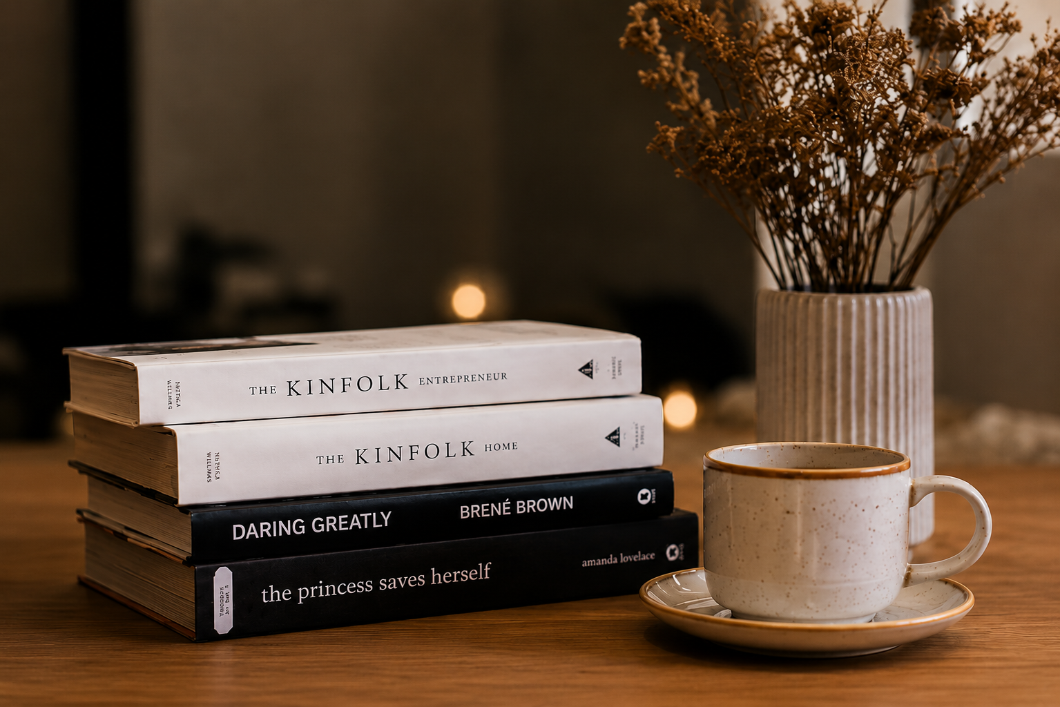 Stack of books and a cup of coffee on a wooden table